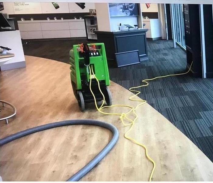 Green SERVPRO equipment on a commercial building floor.